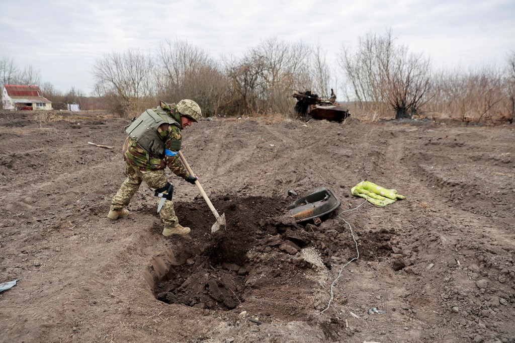 FOTO/ Forcat ukrainase varrosin ushtarin rus dhe pozojnë para tankut të shkatërruar